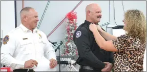  ?? (NWA Democrat-Gazette/Annette Beard) ?? Lt. Tyler Brown (center) was pinned by his wife, Natasha, after Bowen announced his promotion.