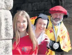  ??  ?? Launch Clara Jones (14) with Stirling Castle actors Mairi Gibson and Hugh Robertson