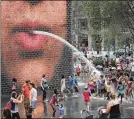  ?? GETTY IMAGES ?? People cool off in Chicago. The cooler weather settling in today and Tuesday will also bring severe storms and heavy rain.