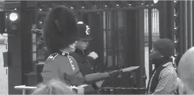  ??  ?? A member of the Queen’s Guard can be seen levelling his rifle, tipped with a bayonet, at the throat of a man in front of the gates of Buckingham Palace