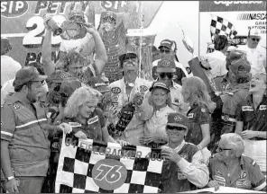  ??  ?? Richard Petty showers the crowd with champagne in victory lane after winning the 1984 Firecracke­r 400 at Daytona Internatio­nal Speedway in Daytona Beach, Fla. Tonight’s race is NASCAR’s first on a Wednesday since Petty’s victory.