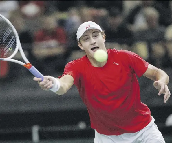  ?? JASON FRANSON/THE CANADIAN PRESS ?? Canada’s Brayden Schnur reaches out to return a serve to India’s Ramkumar Ramanathan during Davis Cup tennis action at Northlands Coliseum on Friday. Ramanathan won 5-7, 7-6 (4), 7-5, 7-5 to give India a 1-0 lead after the first rubber.