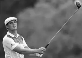  ?? ASSOCIATED PRESS ?? BRYSON DECHAMBEAU FOLLOWS his tee shot on the 18th hole during the third round of the Memorial golf tournament Saturday in Dublin, Ohio.