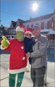  ?? ?? The Grinch was a big hit during the Santa visits with families at the Zuber Insurance office in Boyertown and the Richard A. Zuber Realty office in Royersford.