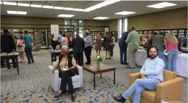  ?? Courtesy of Chris Pedigo ?? Guests enjoy refreshmen­ts and explore Sutter County Library’s new additions and fresh look during its grand re-opening party on Wednesday in Yuba City. The library will be open again to the public on Monday at 10 a.m.