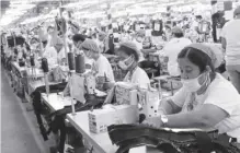  ?? ?? According to employers, if a one-time big-time pay hike were to happen, businesses may either push up the cost of goods to make up for losses due to the wage increase, lay off their workers, or firms still recovering from the impact of COVID-19 may be forced to close. Photo shows laborers at work in a factory at the Mactan Export Processing Zone in Lapu-Lapu City.