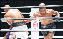  ?? USA TODAY SPORTS ?? Mike Tyson (black trunks) fights Roy Jones, Jr. (white trunks) during a heavyweigh­t exhibition boxing bout for the WBC Frontline Belt at the Staples Center in Los Angeles on Saturday.