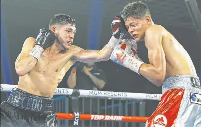  ?? Hector Delacruz Top Rank ?? Junior welterweig­ht Alex Saucedo goes to the head of Sonny Fredrickso­n on Tuesday night at the MGM Grand’s Grand Ballroom.