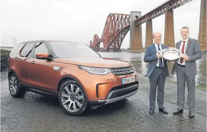  ?? Picture: Stuart Vance. ?? Pictured receiving the accolade from Stephen Park, president, Associatio­n of Scottish Motoring Writers, right, is Jeremy Hicks, managing director of Jaguar Land Rover UK.