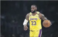  ?? AP FILE ?? In this March 10, 2020, file photo, Los Angeles Lakers’ LeBron James (23) dribbles during the first half of an NBA basketball game against the Brooklyn Nets in Los Angeles.