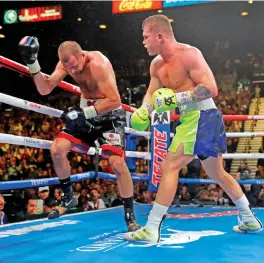  ?? (AFP) ?? Canelo Alvarez knocks out Sergey Kovalev (left) in the 11th round of their WBO light heavyweigh­t fight