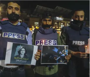  ?? (Abed Rahim Khatib/Flash90) ?? GAZA STRIP journalist­s take part in a candleligh­t vigil in Rafah on Wednesday to denounce the killing of Al Jazeera journalist Shireen Abu Akleh.