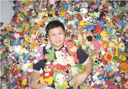  ??  ?? HIS HAPPY MEALS – Percival Lugue, a graphic artist at the Manila Bulletin’s Classified Ads Department, must have enjoyed all the fastfood meals he’s had that to date, he has kept a total of 10,904 souvenirs of them, setting a Guinness world record for the largest collection of fastfood restaurant toys. His most number of kiddie toys? McDonald’s collectibl­es that number 5,947.