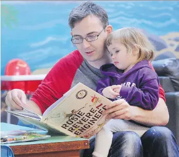  ?? NICK PROCAYLO ?? Denis Ryan and daughter Ada enjoy a story Tuesday at Marpole Community Centre, where Denis and Ada are regulars at the Dad and Me drop-in program. The program begins Saturday after a summer break.