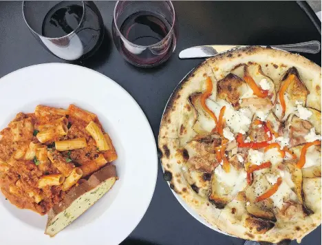  ?? PHOTOS: ALEESHA HARRIS ?? Rigatoni bolognese and patate e pipi pizza are offered at Mangia e Scappa in Fort Langley.
