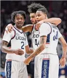  ?? Jessica Hill/Associated Press ?? UConn’s Tristen Newton (2), Andre Jackson Jr. (44) and Jordan Hawkins (24) huddle together in the second half on Nov. 18 in Storrs.