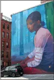  ?? AP/MICHELLE R. SMITH ?? Misty Blue by Andrew Hem, completed in June, is one of the newest murals dotting the walls of downtown Providence, R.I. With a design school, street art and murals, the Rhode Island capital has plenty to attract art lovers.