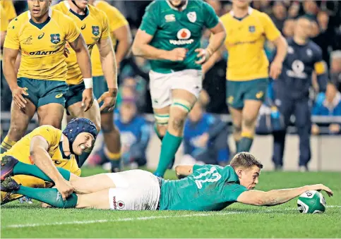  ??  ?? Stretching a point: Centre Garry Ringrose gets the ball over the line for Ireland’s second try against Australia yesterday