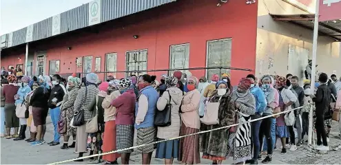  ?? Picture: Lulamile Feni ?? Social grant beneficiar­ies queue in Mqanduli in the Eastern Cape to access their grant payments during the Covid pandemic. The government will pay R945bn to grant beneficiar­ies over the next three years.