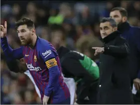  ??  ?? FC Barcelona’s Lionel Messi (left) gestures next to his coach Ernesto Valverde during the Spanish La Liga soccer match between FC Barcelona and Valencia at the Camp Nou stadium in Barcelona, Spain, on Saturday. AP PHOTO/MANU FERNANDEZ