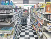  ?? KENN OLIVER/THE TELEGRAM ?? A staffer stocks shelves at Belbin’s Grocery on Wednesday morning. The 75-year-old store has been bought out by Colemans, but the plan involves keeping all 27 staff on board, as well as the grocer’s signature products and services like its popular Dinner’s Ready pre-made meals.