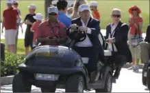  ?? LUIS M. ALVAREZ, THE ASSOCIATED PRESS ?? Donald Trump drives himself around the golf course to watch the final round of the 2016 Cadillac Championsh­ip.