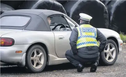  ?? Picture: Matthew Horwood ?? Police pull over motorists at a checkpoint during Wales’s fire-break lockdown.