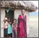  ?? (TNS) ?? A Maasai family gathers outside their hut, which has been outfitted with a healthy clean-cooking stove in Tanzania&apos;s Monduli district.