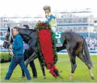  ?? PHOTO BY KAREEM ELGAZZAR/THE CINCINNATI ENQUIRER VIA AP ?? John Velazquez celebrates after riding Always Dreaming to victory in the 143rd running of the Kentucky Derby at Churchill Downs on Saturday.