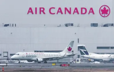  ?? PETER J THOMPSON / FINANCIAL POST ?? An Air Canada jet prepares for take off from Toronto's Pearson Airport Wednesday. The airline, battered by nearly a
year of COVID-19 travel restrictio­ns, has reduced staff and is cutting flights to remote markets across Canada.