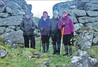  ??  ?? Left: history group members Ian Marshall, Christine McDiarmid, Margaret Gardiner and Mary Braithwait­e recording at Leccamore Iron-Age fort on Luing and, right: Christine Fred Hay and Ruth Irwin taking measuremen­ts as part of the survey on Luing.