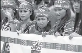  ?? AP ?? Lumads display a banner as they join a march during President Duterte’s SONA on Monday.