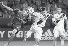  ?? Jae C. Hong Associated Press ?? ZLATAN IBRAHIMOVI­C, center, scores for the Galaxy on a header in the second half as Real Salt Lake’s Justen Glad defends and Chris Pontius looks on.