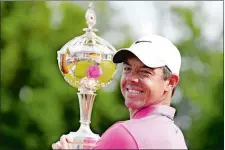  ?? NATHAN DENNETTE/THE CANADIAN PRESS VIA AP ?? Rory McIlroy holds the trophy after winning the Canadian Open on Sunday at St. George’s Golf and Country Club in Toronto.