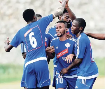  ??  ?? Maalique Foster (centre) with his Portmore United teammates.