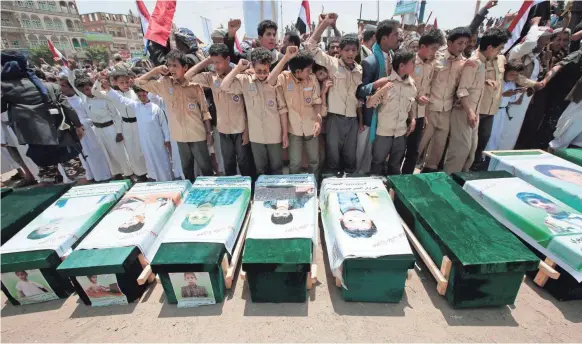  ?? AP ?? People attend a funeral Monday of victims, several of them children, of a Saudi-led airstrike in Saada, Yemen.