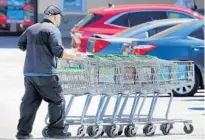  ?? JOE BURBANK/ORLANDO SENTINEL ?? A Publix employee wears a mask while retrieving shopping carts at their North Orlando Avenue store in Winter Park on April 2.