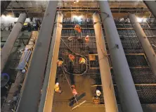  ?? Michael Macor / The Chronicle ?? Workers more than 100 feet below ground are seen through trusses as they pour concrete to create the Union Square Station platform of the Central Subway, which faces a long delay.