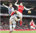  ??  ?? LONDON: West Bromwich Albion’s English defender Craig Dawson (L) vies with Arsenal’s Chilean striker Alexis Sanchez during the English Premier League football match between Arsenal and West Bromwich Albion at the Emirates Stadium in London yesterday. —...