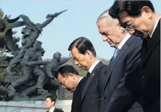  ?? PHOTO REUTERS ?? US Defence Secretary James Mattis (second from right) and his South Korean counterpar­t Han MinKoo (third from right) pay a silent tribute during a visit to the national cemetery in Seoul, South Korea, yesterday.