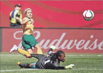  ?? Kevin C. Cox
Getty Images ?? KYAH SIMON (17) of Australia scores past goalkeeper Precious Dede of Nigeria in Winnipeg.