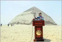  ?? MOHAMED EL-SHAHED/AFP ?? Egypt’s Antiquitie­s Minister Khaled El-Enany speaks in front of the Bent Pyramid of Sneferu during an inaugural ceremony of the pyramid and its satellites on Saturday.