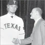  ?? Kai Nishimura Associated Press ?? THE TEXAS Rangers paid $111.7 million in fees and salary to bring Yu Darvish to U.S. in 2011. His Iranian father, Farsad Darvishsef­ad, attended the signing.