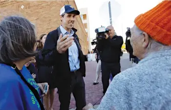  ?? Eric Gay/Associated Press, File ?? ■ Rep. Beto O’Rourke, the 2018 Democratic candidate for Senate in Texas, center, greets voters heading to the polls Nov. 16 after he voted in El Paso, Texas. O’Rourke barged into last year’s Texas Senate race almost laughably early in March 2017. Now, as the onetime punk rocker mulls a much-hyped White House bid for 2020, he’s doing anything he can to stay in the spotlight without formally starting a campaign.