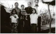  ?? CONTRIBUTE­D BY PAUL PAQUETTE ?? Nalie Lee-Wen is being held by her mother in this photo from a refugee camp. Next to Nalie is her mother’s mother. On the left is her sister Xe, then sister Tsong and sister Neng, and her father. “I was always their ‘ray of sunshine,’” Lee-Wen says....