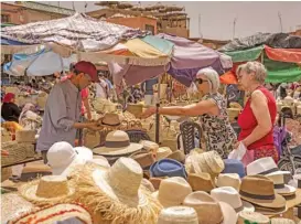  ?? (aFP) ?? Tourists shop around in the old city of Morocco’s Marrakesh last week