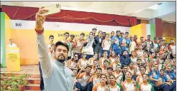  ?? HT ?? Sports minister Anurag Thakur takes a selfie with Khelo India University Games athletes.