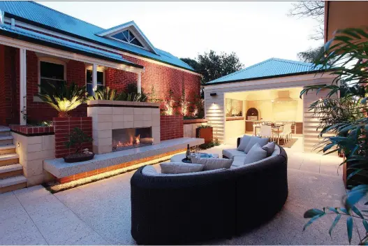  ?? PHOTOS (3): COURTESY OF ECOSMART ?? An outdoor fireplace and ambient lighting makes the patio area of this home an appealing place to gather, even when the weather cools.