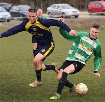  ??  ?? Robert Cousins of Rosslare Rangers closes in on Darren Brennan of Gorey Celtic during their Wexford Volkswagen Cup fourth round tie.