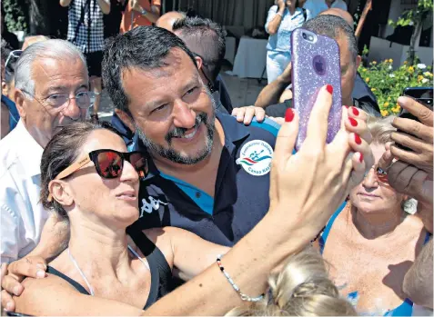  ??  ?? Matteo Salvini poses for a selfie with revellers. Below, the politician at Milano Marittima in Italy Giuseppe Conte, the prime minister who quit by accusing Mr Salvini of wrecking Italy’s y pp populist government